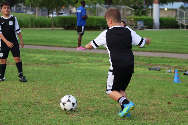 A player in blue cleats prepares to pass the ball