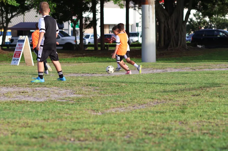 A young player in orange prepares a shot