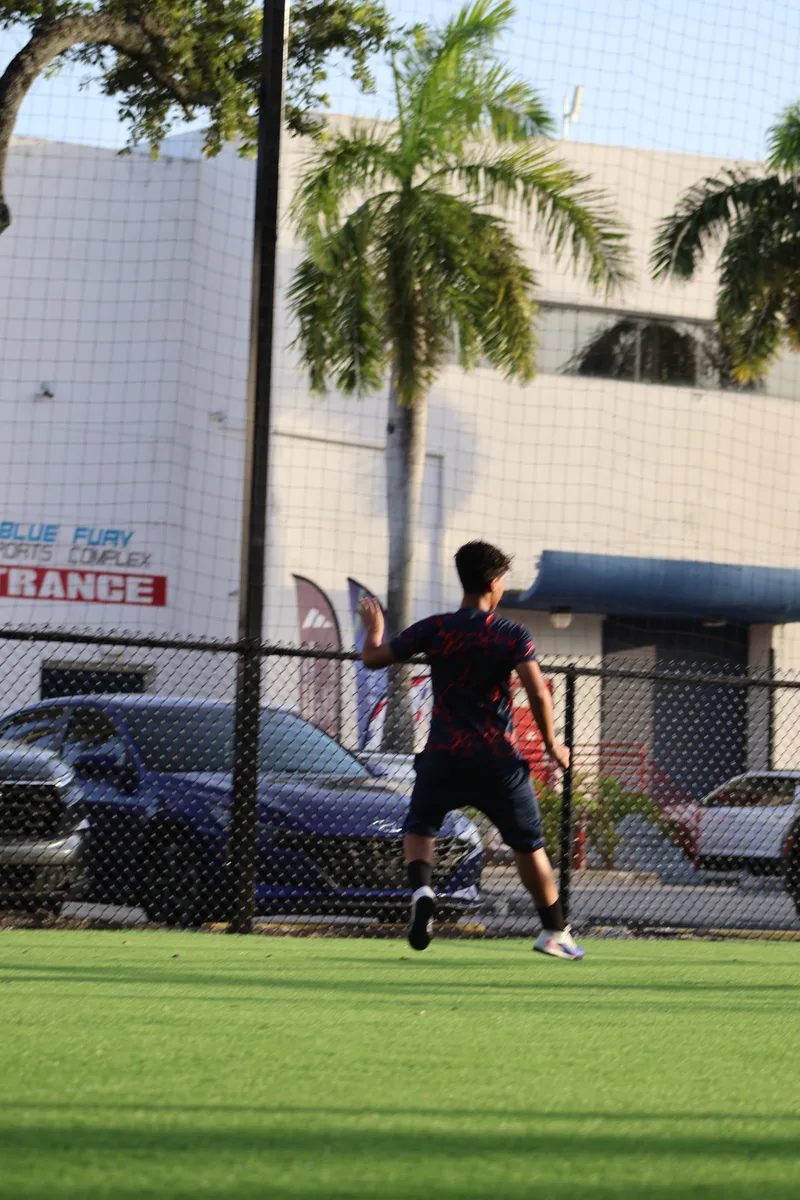 A player practices footwork near the perimeter fence
