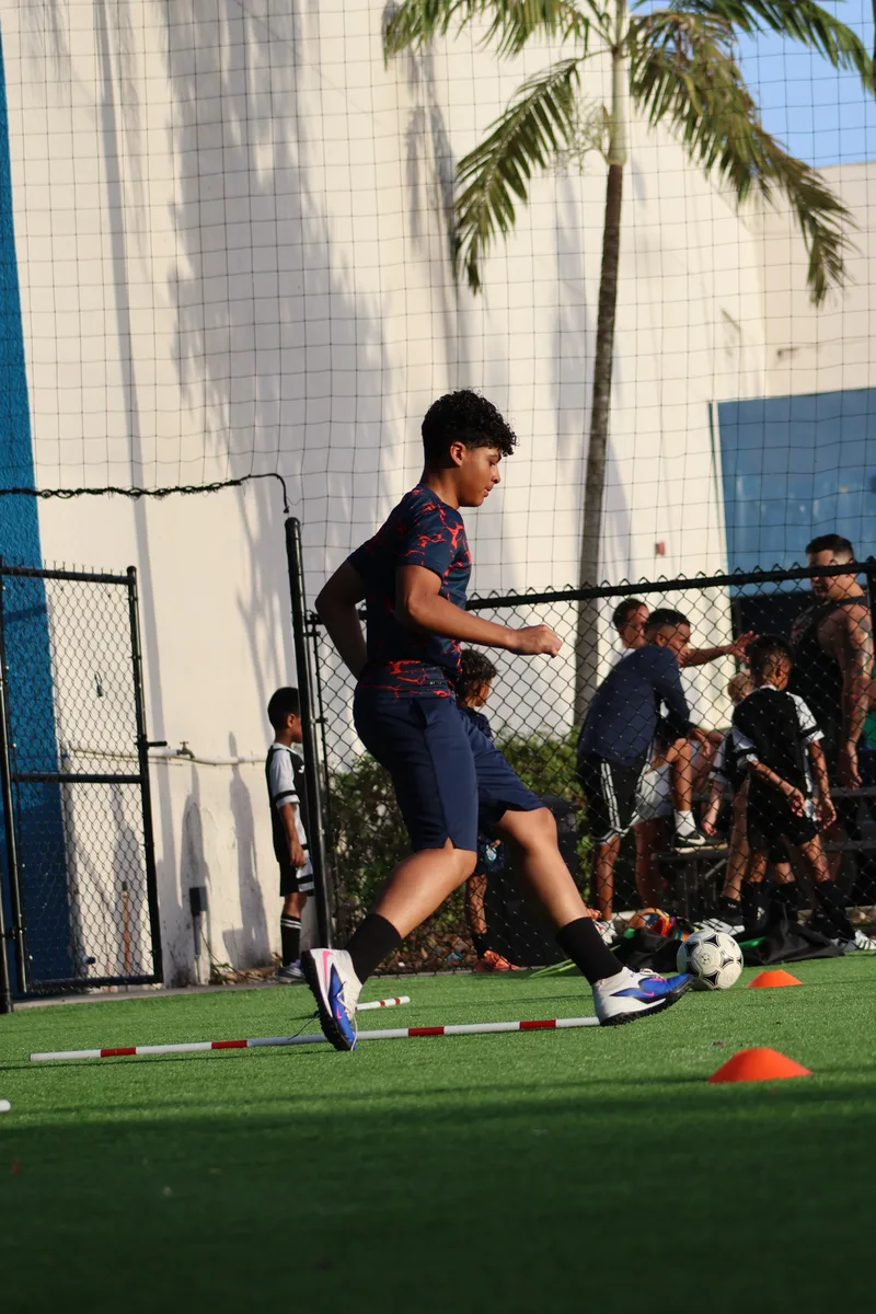 A player strikes the ball beside a line of cones